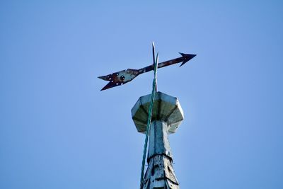 Low angle view of crane against sky