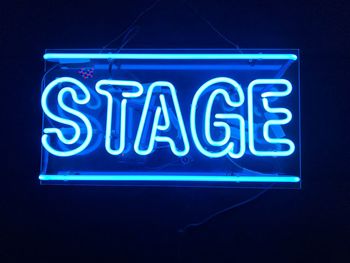 Close-up of illuminated stage text