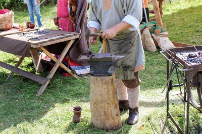 Low section of man working on wood