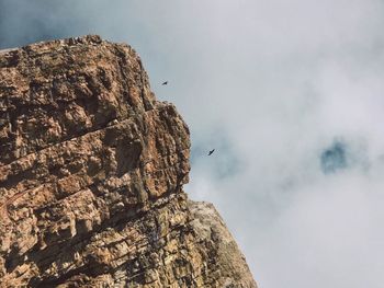 Low angle view of rock formation against sky