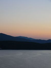 Scenic view of mountains against clear sky during sunset