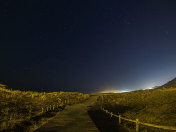 Scenic view of road against sky at night