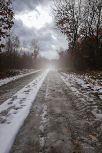 Surface level of road against sky during winter
