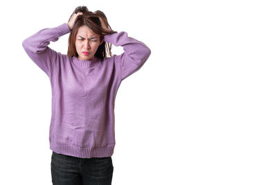 Mid adult woman standing against white background