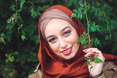 Portrait of smiling young woman wearing hijab