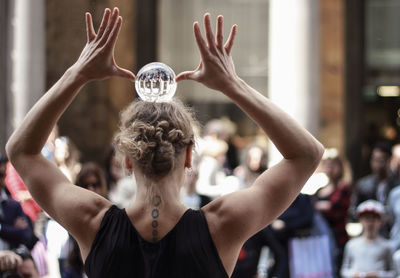 Rear view of woman dancing outdoors