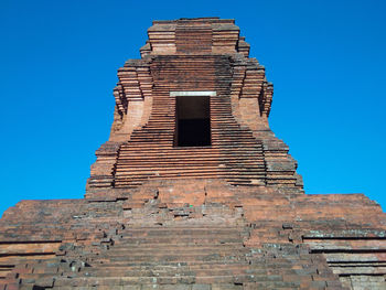 Low angle view of historical building against clear blue sky