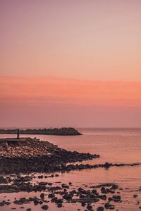 Scenic view of sea against orange sky