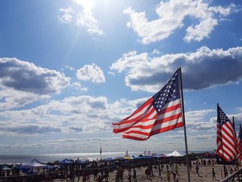 American flags against sky