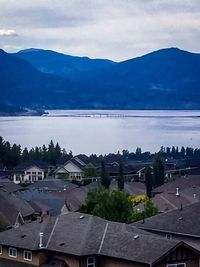 Houses in town against cloudy sky