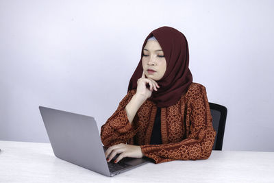 Low angle view of woman using mobile phone