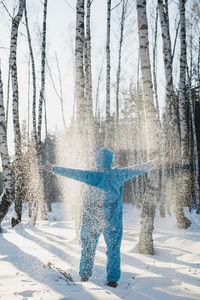 Woman with arms outstretched in snow