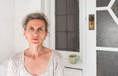 Portrait of woman standing at home