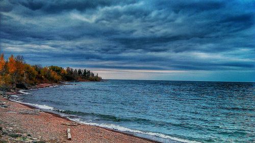 Scenic view of sea against cloudy sky