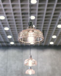 Low angle view of illuminated lamps in room