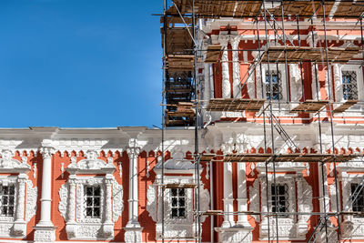 Low angle view of abandoned building against clear blue sky