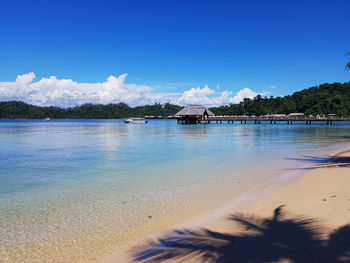 Scenic view of beach against blue sky