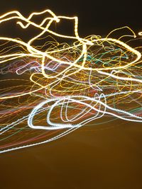 Close-up of light trails against sky at night