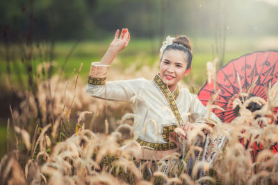 Portrait of smiling young woman on field