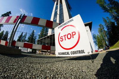 Low angle view of road sign against sky