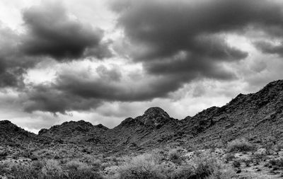 Scenic view of mountains against cloudy sky