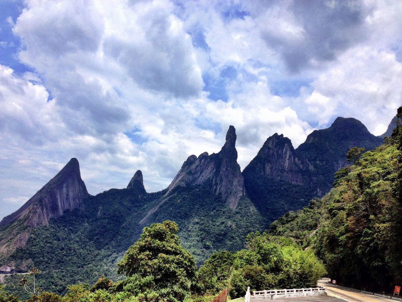 mountain, sky, scenics, mountain range, tranquil scene, tranquility, beauty in nature, tree, cloud - sky, landscape, nature, cloud, rocky mountains, physical geography, rock formation, non-urban scene, geology, cloudy, idyllic, rock - object