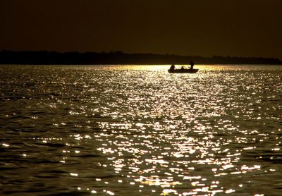 Silhouette boat in calm sea