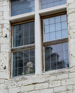 Low angle view of window in abandoned building