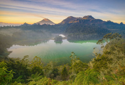 Scenic view of lake and mountains against sky