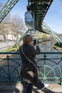 Middle-aged woman making a report of the wuppertal suspension railway train