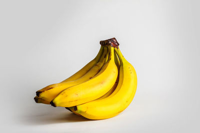 Close-up of yellow fruit against white background