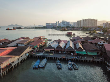 High angle view of bay and buildings against sky