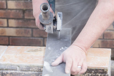 Close-up of man working on metal