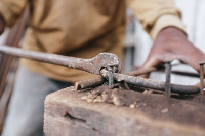 Close-up of person bending a steel bar on a  construction site