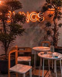 Empty chairs and tables in restaurant at night