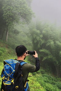 Backpacking and hiking, misty and foggy singalila forest on himalayan foothills, darjeeling in india 