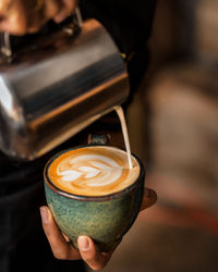 Cropped hand holding coffee