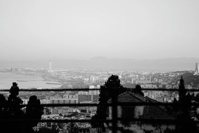 High angle view of city buildings against clear sky