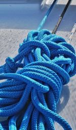 High angle view of blue tied ropes on boat