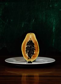 Close-up of orange slice in plate on table