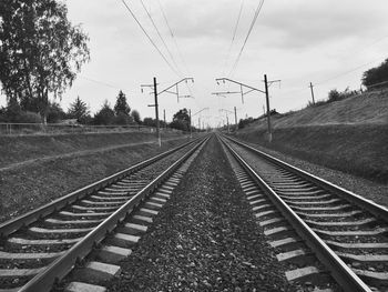 Surface level of railroad tracks against sky
