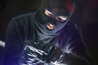 Portrait of burglar holding gun