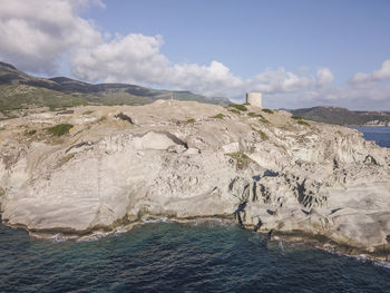 Scenic view of sea and mountains against sky