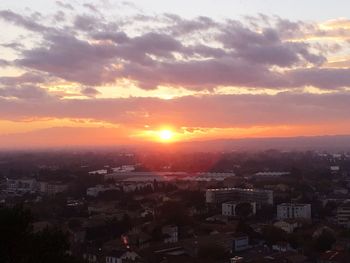 Aerial view of cityscape against sky during sunset