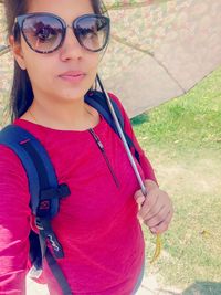 Portrait of woman wearing sunglasses standing outdoors