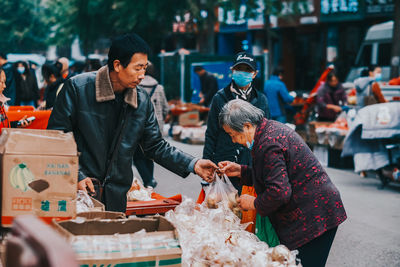 People at market stall