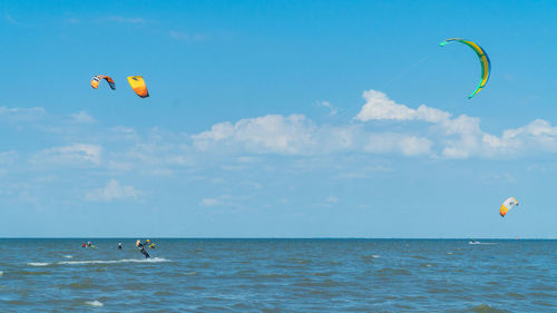 Kite flying over sea against sky