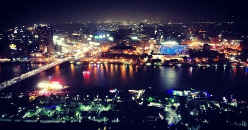 High angle view of illuminated buildings in city at night