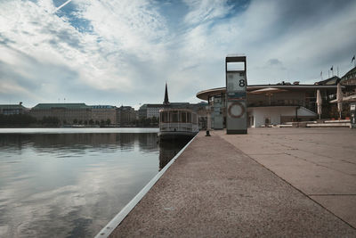 Bridge over river against buildings in city