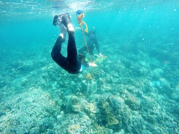 Full length of women snorkeling in turquoise sea